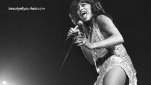 Tina Turner tribute image with candlelight background representing her passing and musical legacy